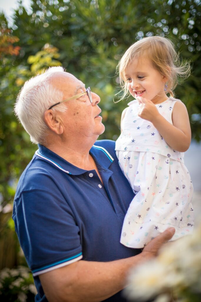 Grandfather and little granddaughter celebrating homecoming
